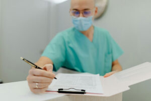 Doctor doing research on scrubs and mask.